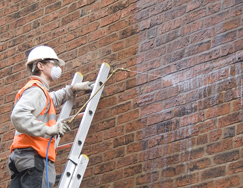 engineer on site handling a job for damp proofing in Mossley